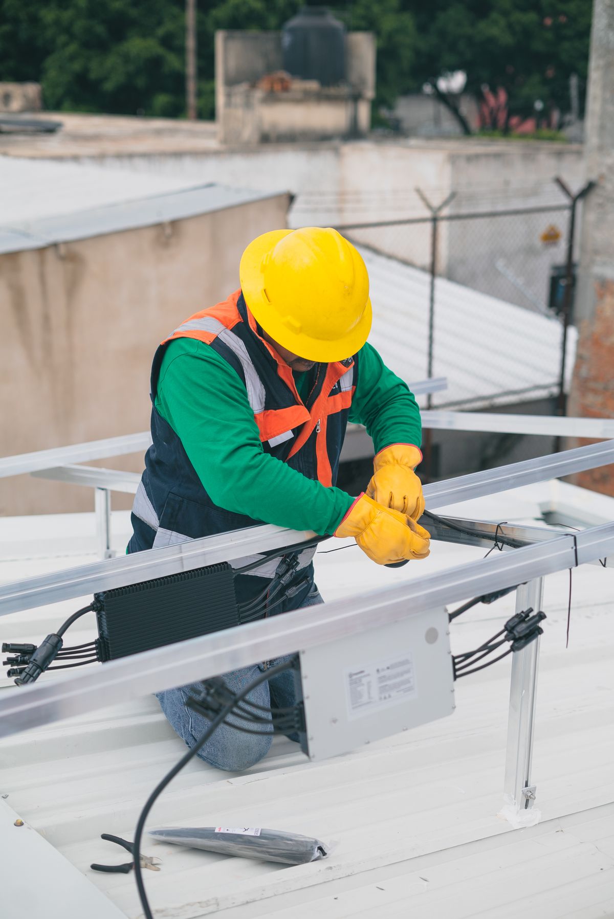 Electrician in safety gear working on a commercial electrical installation